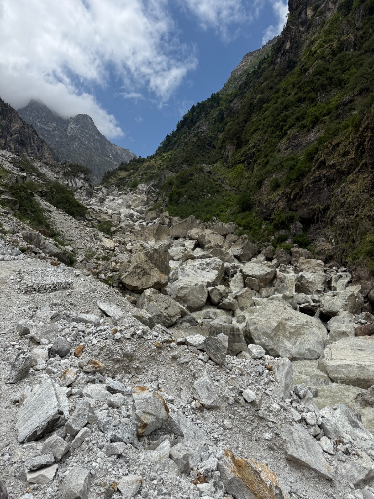 Wild glacier river flowing through a boulder-filled mountain gorge